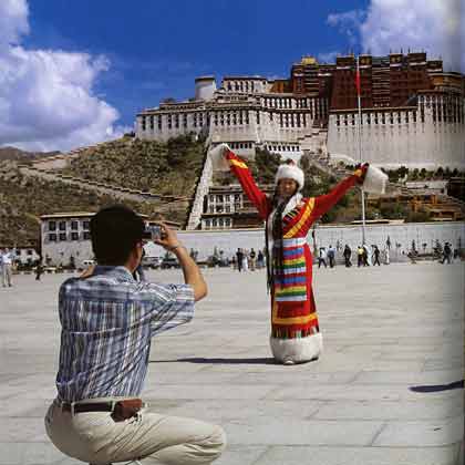 
Chinese Tourist Poses In Tibetan Costume In Front Of Potala Palace In Lhasa - Tibet: Escape From The Roof Of The World by Dieter Glogowksi book
